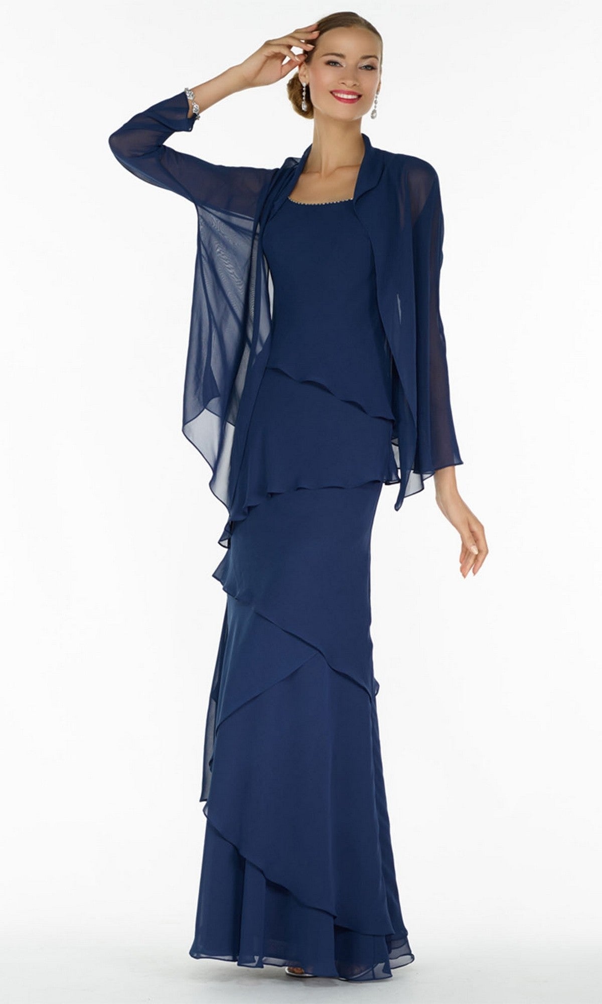 A woman stands against a white background wearing the Alyce 29292 long formal dress, a navy chiffon sleeveless, floor-length evening gown with layered skirt and a matching sheer jacket for an elegant look.